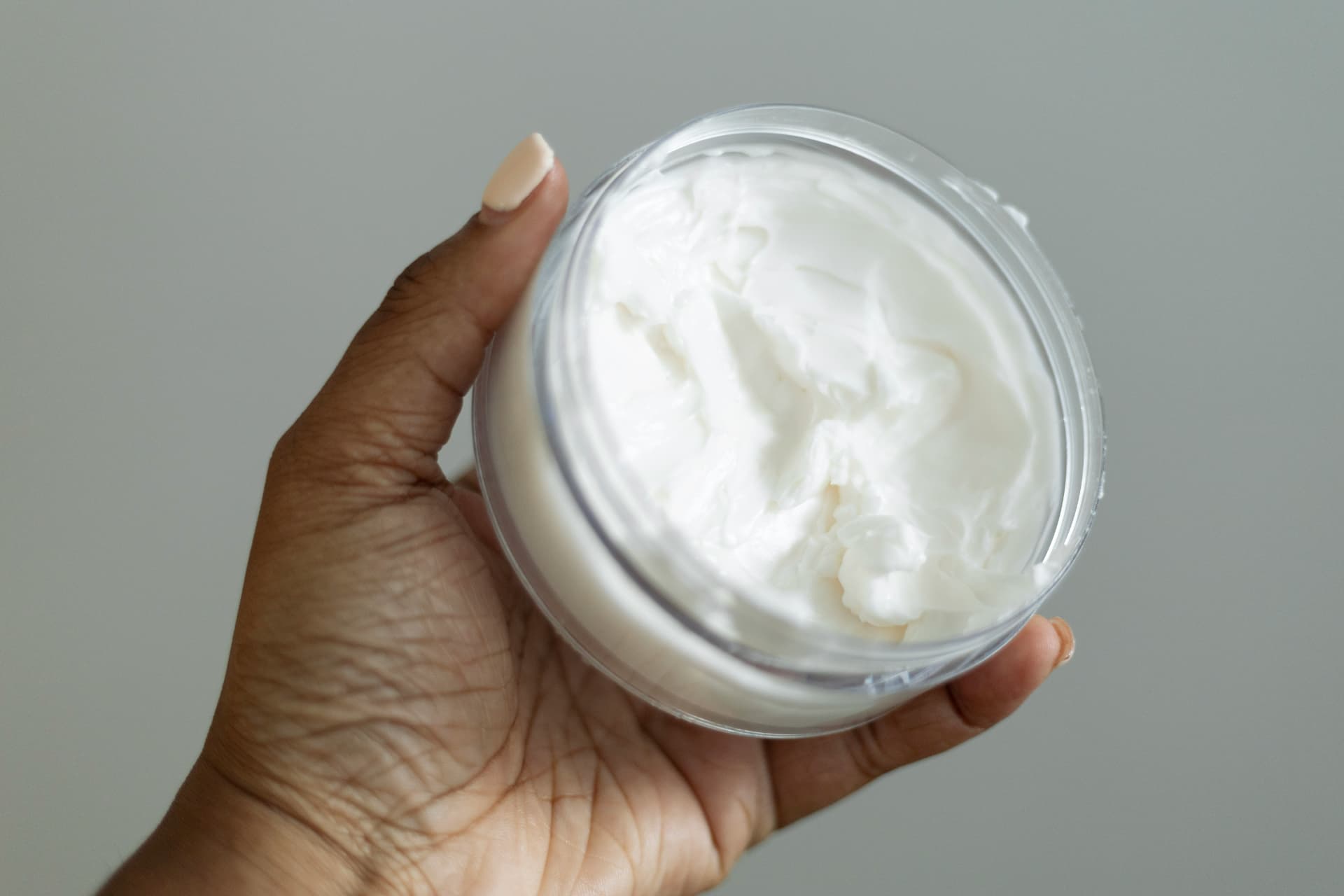Cream jar held in a hand
